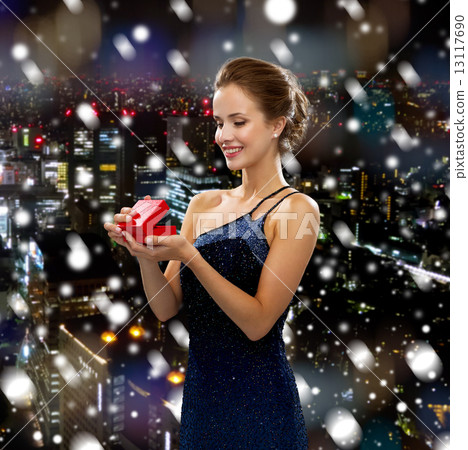 smiling woman holding red gift box smiling woman holding red gift box 13117690