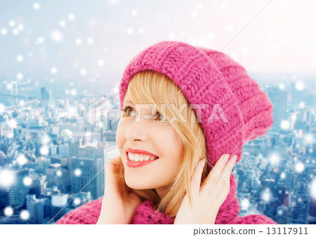 smiling young woman in winter clothes 13117911