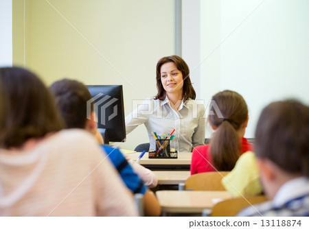 group of school kids raising hands in classroom group of school kids raising hands in classroom 13118874