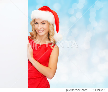 smiling young woman in santa hat with white board 13119343