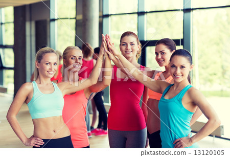 group of women making high five gesture in gym 13120105