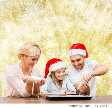 happy family in santa helper hats cooking 13120412