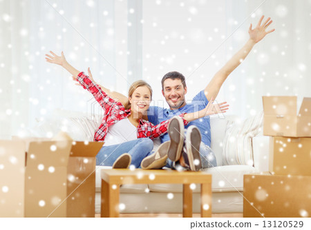 smiling couple relaxing and waving hand at home 13120529