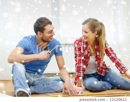 smiling couple measuring wood flooring smiling couple measuring wood flooring 13120621