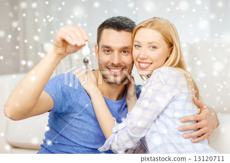 smiling couple holding keys at home 13120711
