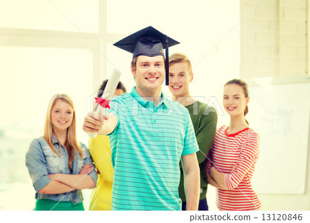 smiling male student with diploma and corner-cap 13120846