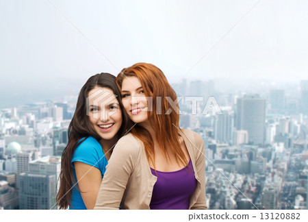 smiling teenage girls hugging smiling teenage girls hugging 13120882