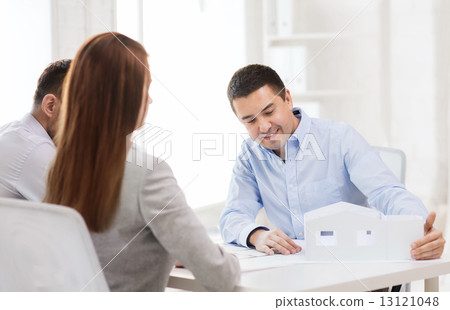 couple looking at model of their house at office couple looking at model of their house at office 13121048