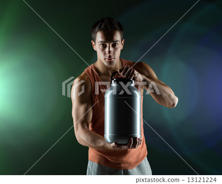 young male bodybuilder holding jar with protein young male bodybuilder holding jar with protein 13121224