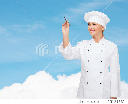 smiling female chef writing something on air 13121281