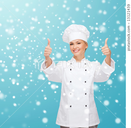smiling female chef showing thumps up 13121439