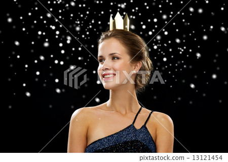 smiling woman in evening dress wearing crown 13121454