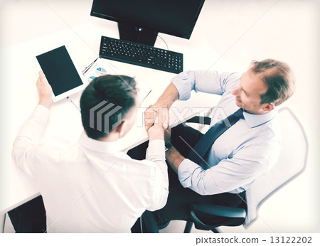businessmen shaking hands in office businessmen shaking hands in office 13122202