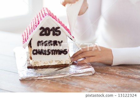 close up of woman making gingerbread houses close up of woman making gingerbread houses 13122324