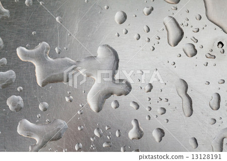 Metal surface covered in water drops. 13128191
