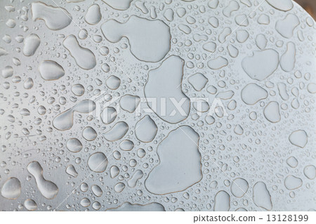 Metal surface covered in water drops. 13128199