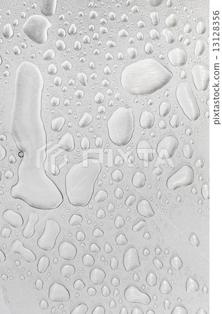 Metal surface covered in water drops. 13128356