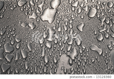 Metal surface covered in water drops. 13128360