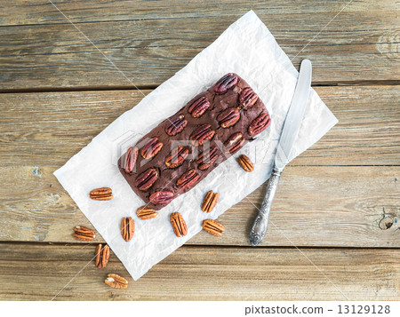 Pecan brownie cake on a wooden background 13129128