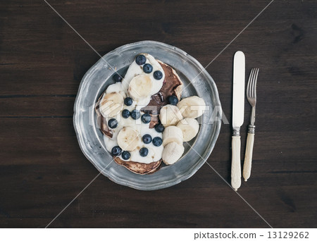 Breakfast set on dark wooden desk 13129262