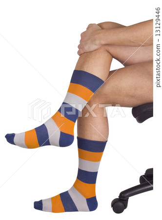 Male legs in colorful socks. Isolated on white 13129446