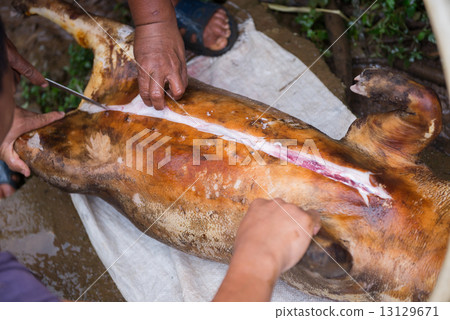 cutting up pork with knife 13129671