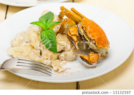 Italian gnocchi with seafood sauce with crab and basil Italian gnocchi with seafood sauce with crab and basil 13132597