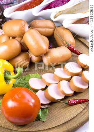 sausage on a wooden plate in a restaurant 13133635