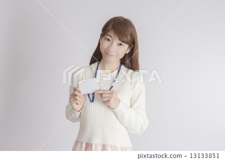 A woman showing an ID card A woman showing an ID card 13133851