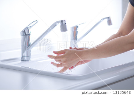 A woman washing her hands A woman washing her hands 13135648