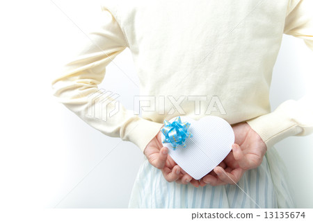 A woman with a heart-shaped gift 13135674
