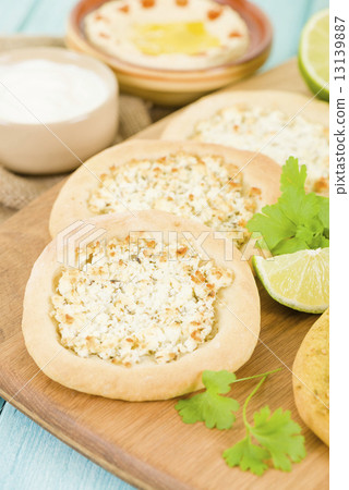 Cheese Manakish - Flatbread topped with cheese. Traditional Arab food. Cheese Manakish - Flatbread topped with cheese. Traditional Arab food. 13139887