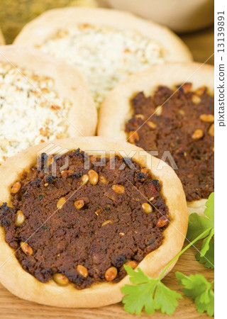 Lahm Bi Ajin, Zaatar and Cheese Manakish - Flatbreads topped with minced lamb, cheese and zaatar. Lahm Bi Ajin, Zaatar and Cheese Manakish - Flatbreads topped with minced lamb, cheese and zaatar. 13139891