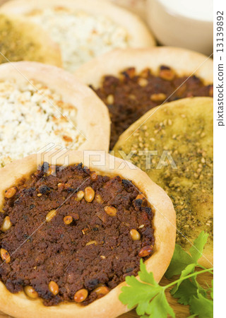 Lahm Bi Ajin, Zaatar and Cheese Manakish - Flatbreads topped with minced lamb, cheese and zaatar.  13139892