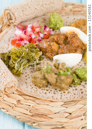 Ethiopian Feast - Injera with doro wat, yebeg alicha, misir wat, kik alicha, and gomen  13140561