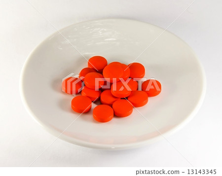 Red pills on a plate 13143345