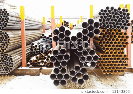 piles of different pipes in outdoor warehouse piles of different pipes in outdoor warehouse 13143803