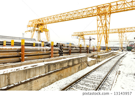 overhead cranes over railroad in outdoor warehouse 13143957