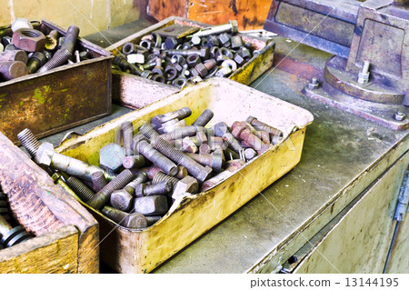boxes with old bolts on workbench in turnery boxes with old bolts on workbench in turnery 13144195
