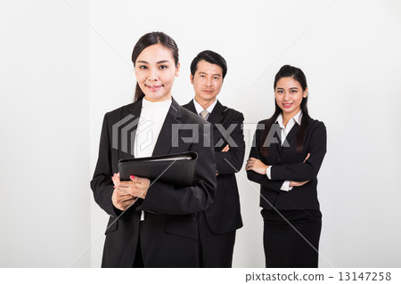 Asian business women smiling with colleagues at background Asian business women smiling with colleagues at background 13147258