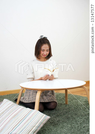 Young woman reading a book 13147577