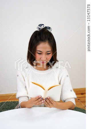 Young woman reading a book 13147578
