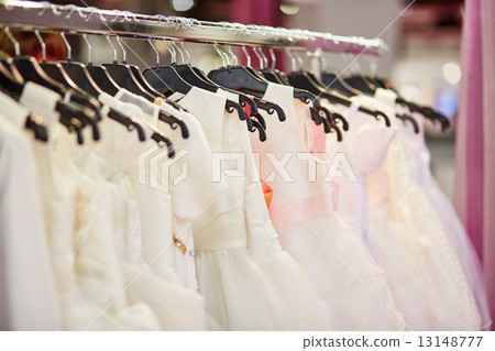 Collection of wedding dresses in a shop Collection of wedding dresses in a shop 13148777
