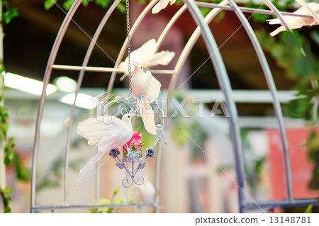 White doves holding golden rings in their beaks 13148781