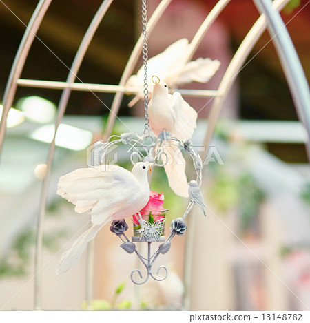 White doves holding golden rings in their beaks 13148782