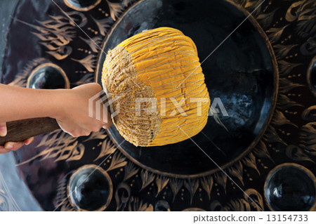 Hand hit big gong in temple  13154733