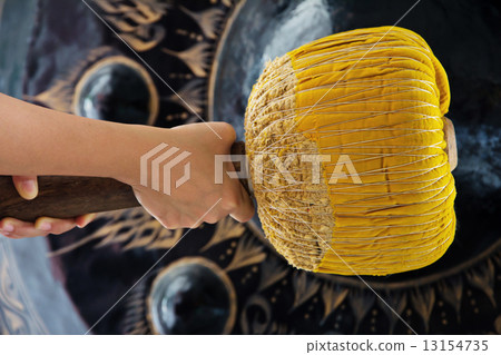 Hand hit big gong in temple  13154735