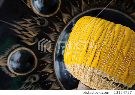 Hand hit big gong in temple  13154737