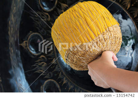 Hand hit big gong in temple  13154742