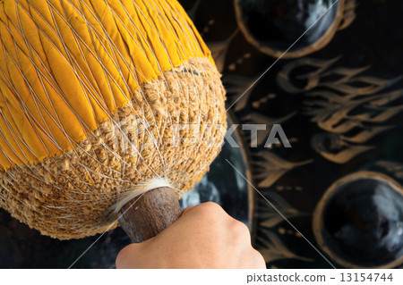 Hand hit big gong in temple  13154744